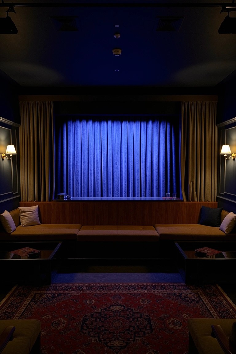 Intimate lounge with navy blue curtained wall, wooden benches with cushions, low tables, and Persian rug under warm wall lamps