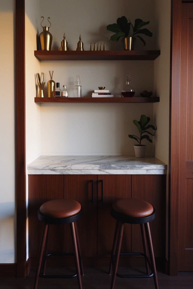 Recessed wooden bar cabinets with white marble countertop, gold vases and bottles on open shelves, potted plants, and two leather bar stools