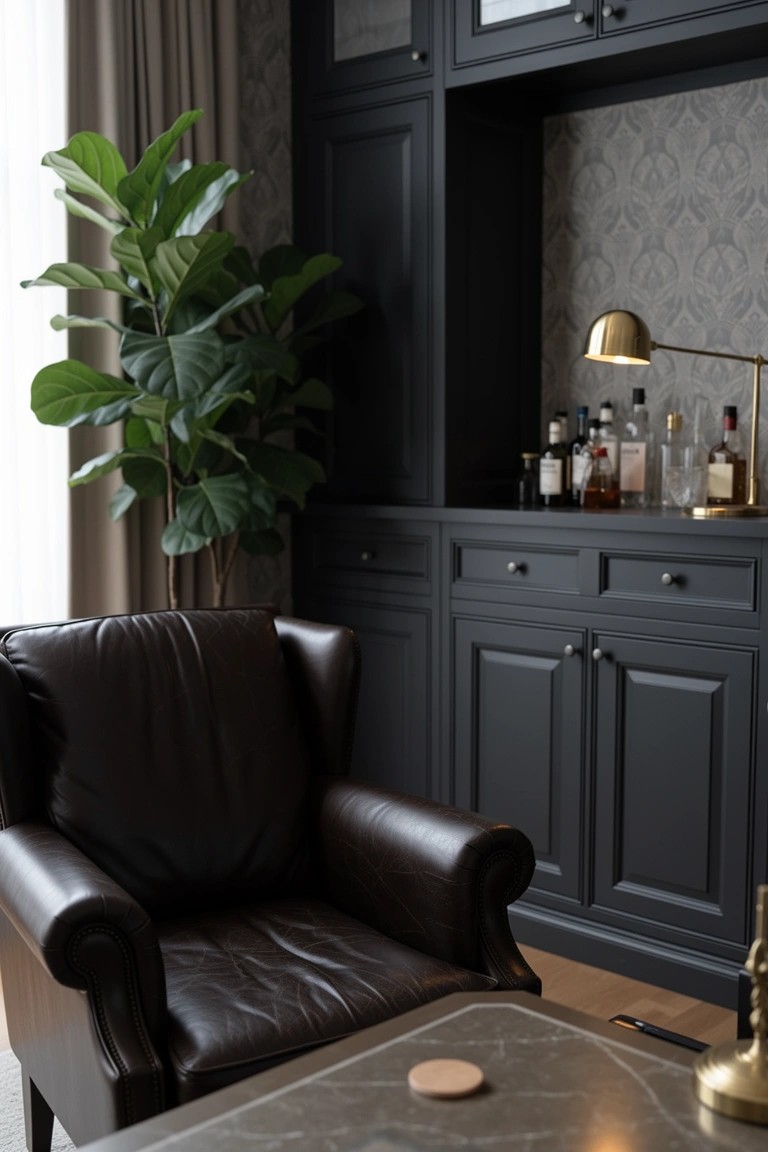 Dark wood built-in bar cabinetry displaying liquor bottles, with a leather armchair and table lamp nearby