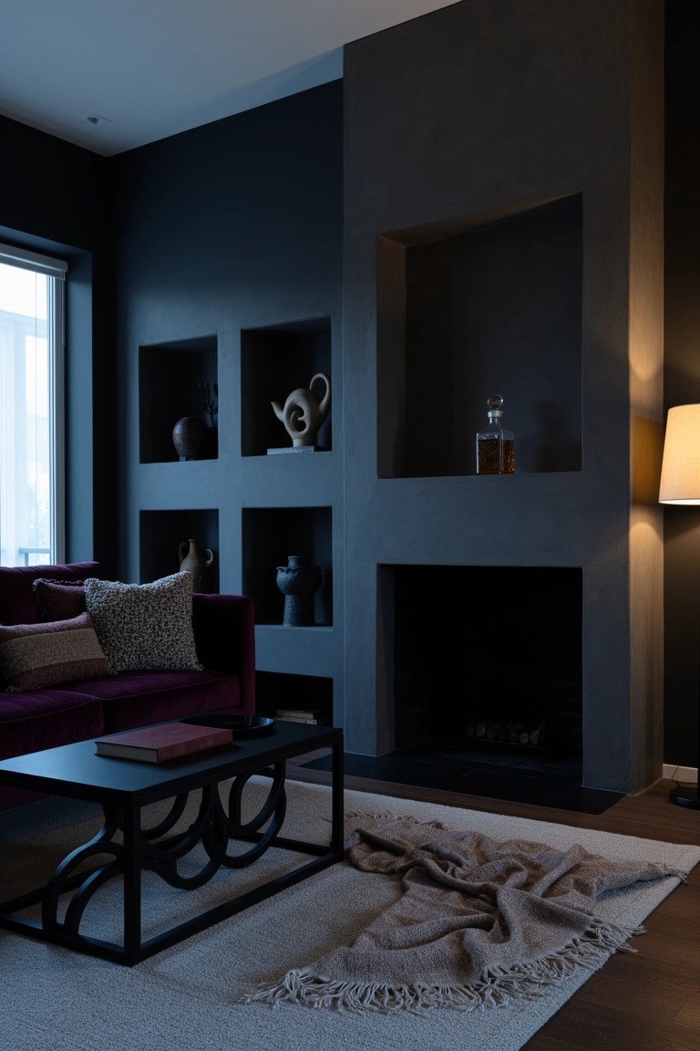 Dark-walled sitting room with built-in niches displaying vases, purple velvet sofa, black coffee table, and empty fireplace