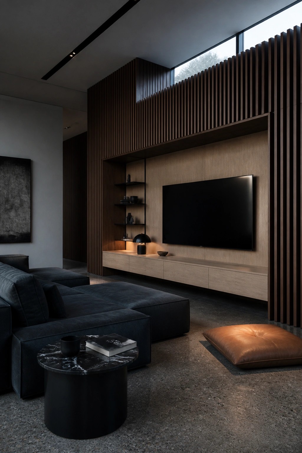 A living room with a dark sectional sofa, round coffee table, and a large wood wall with vertical slats, built-in shelves, and a mounted television.