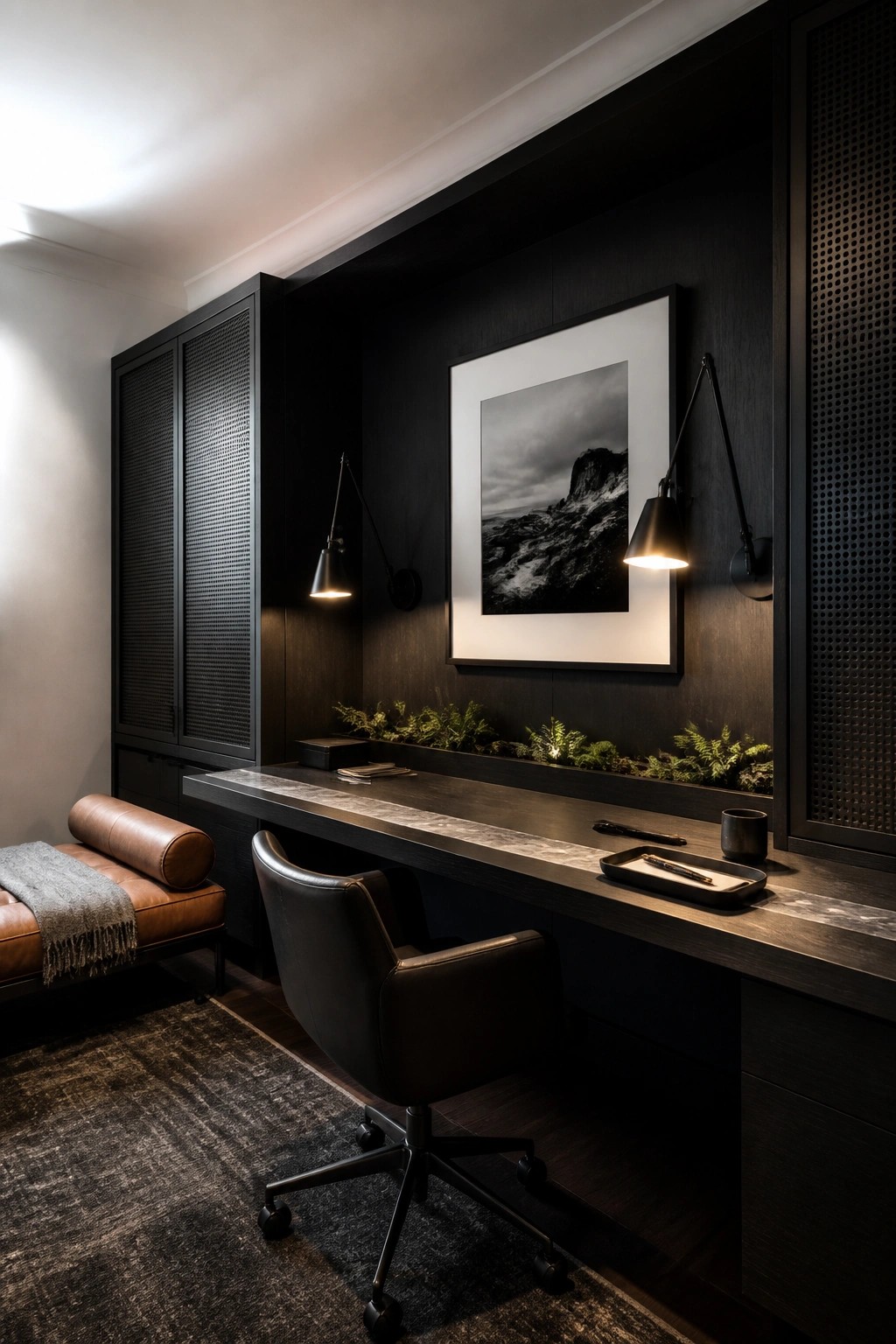 A dark masculine home office featuring a long built-in desk, black leather office chair, wall sconces, and tall dark wood cabinets with mesh doors.