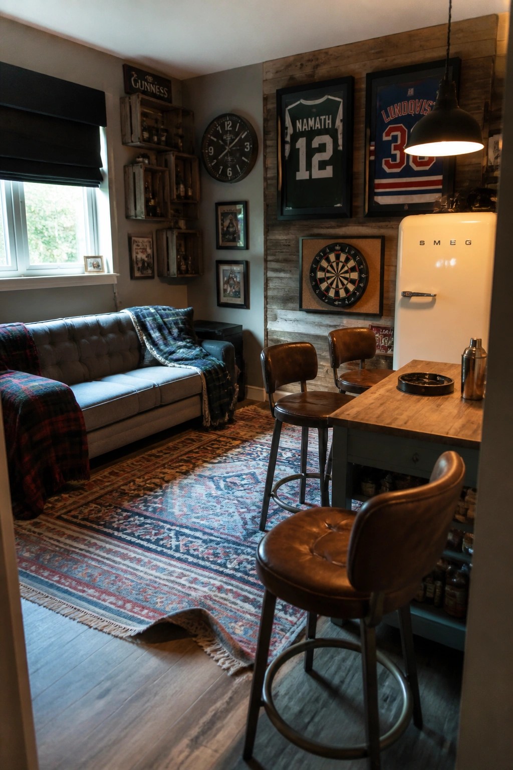 A man cave interior with three brown leather bar stools around a wooden counter, a white retro fridge, a dartboard on wood paneling, framed sports jerseys, and a gray sofa on a patterned rug.