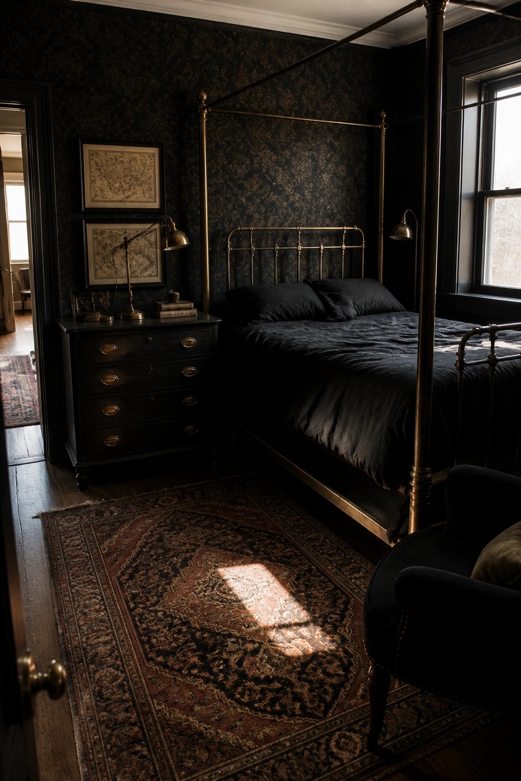 A dark bedroom with black patterned walls, a brass four-poster bed with black bedding, brass lamps, a black dresser, and a large patterned rug on the floor.