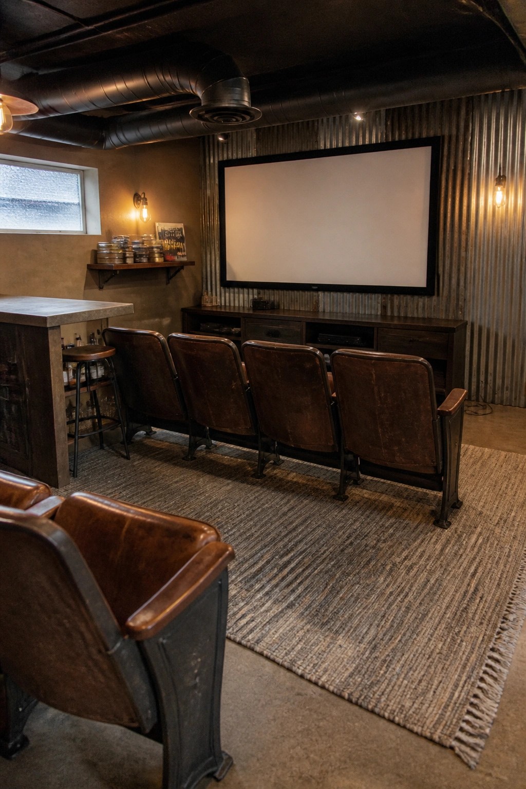 Industrial home theater with rows of brown leather seats facing blank screen.