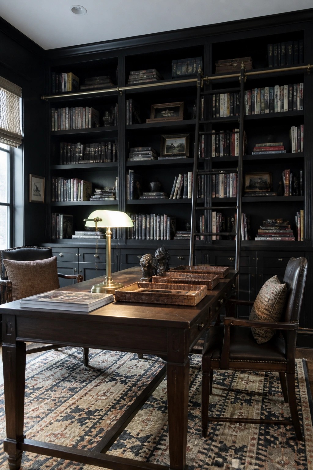 A dark wood home office with floor-to-ceiling built-in bookshelves, a rolling ladder, a wooden desk with a brass lamp, and two leather chairs on a patterned rug.