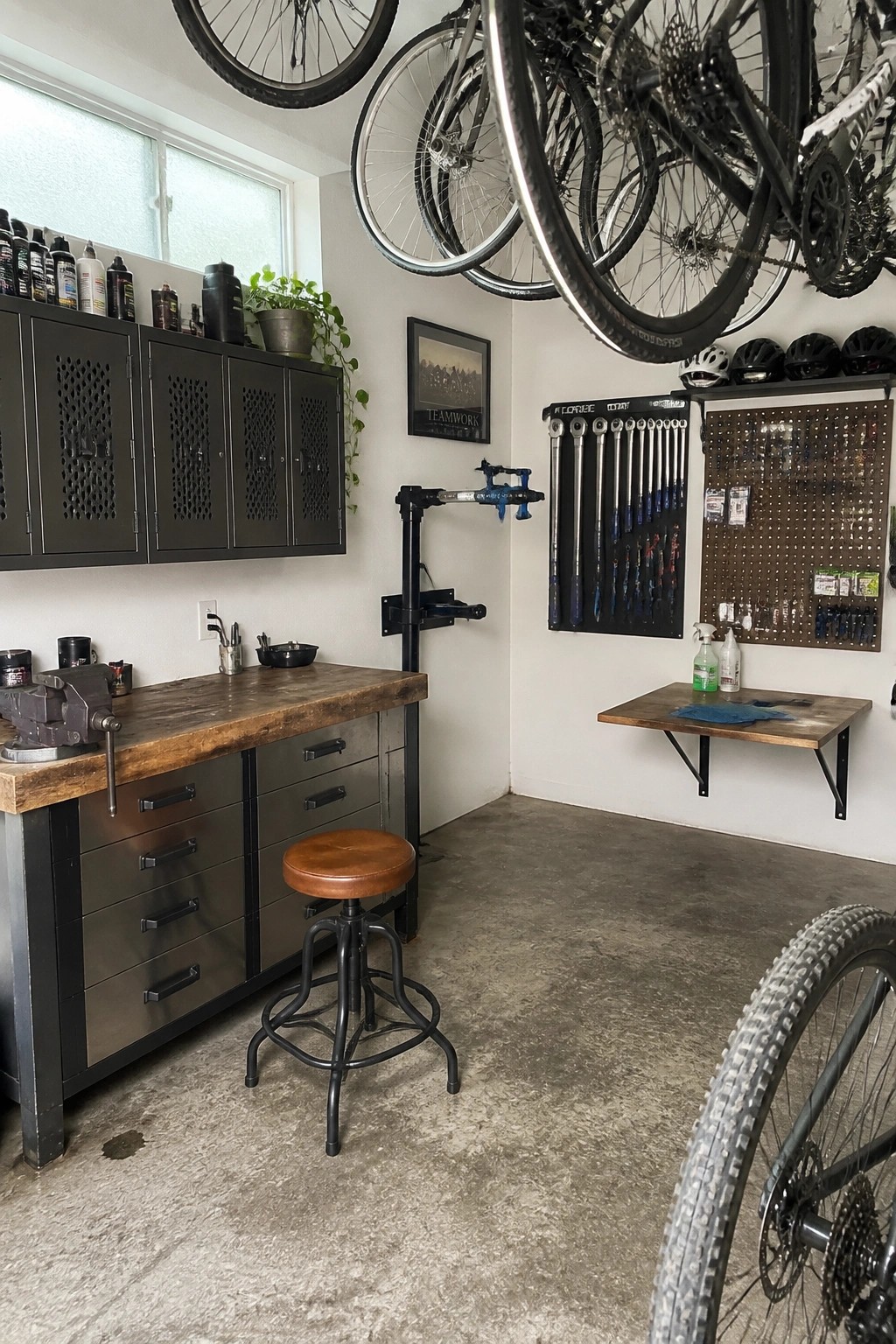 Bicycle repair shop with workbench, stool, pegboard tools, and hanging bikes.