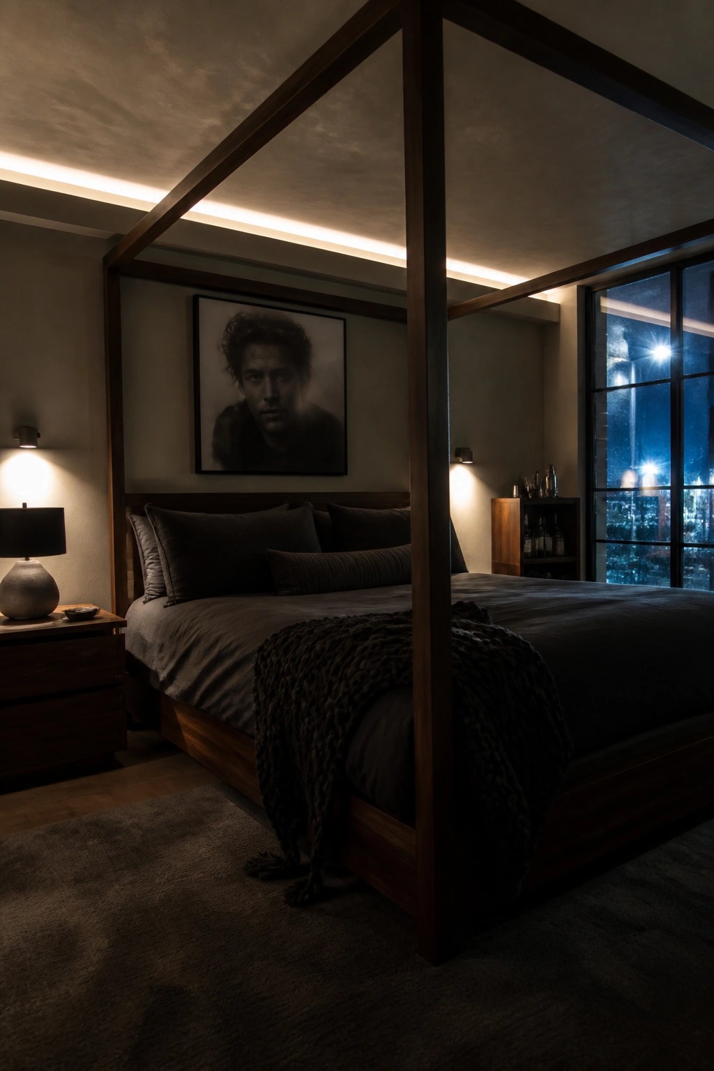 Dark wooden four-poster bed with gray linens in dimly lit modern bedroom at night