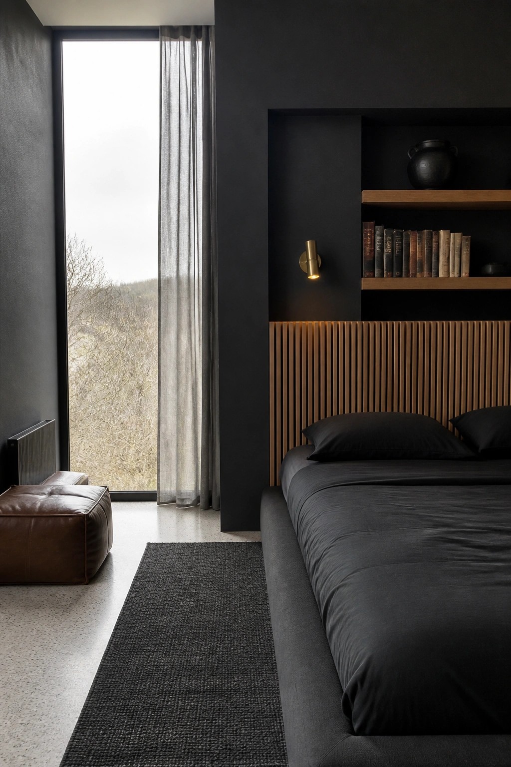 Modern dark bedroom with black bed, wooden headboard, bookshelves, and tall window.