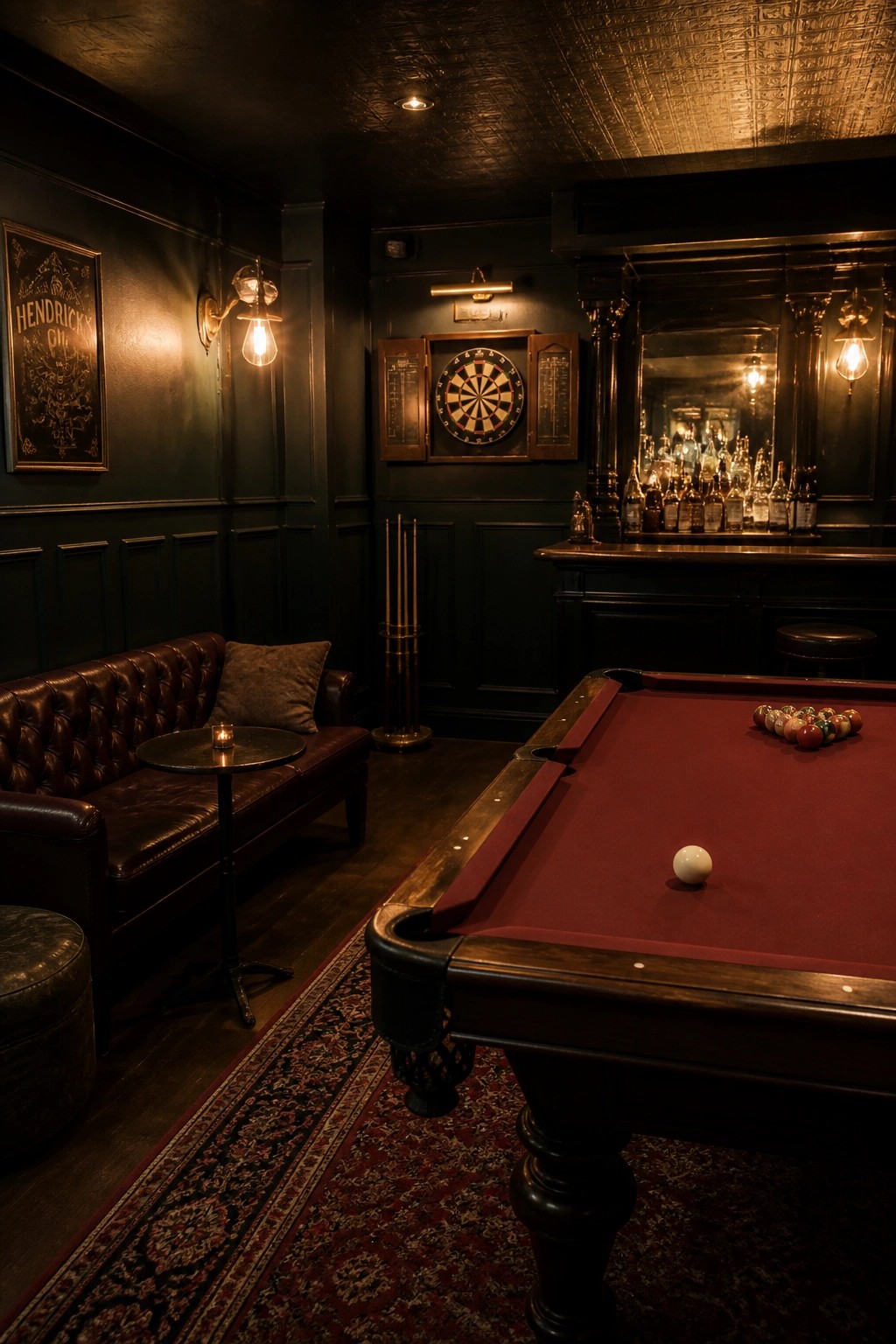 A dimly lit game room featuring a pool table, dartboard mounted on dark paneled walls, a leather sofa, and a bar area in the background.