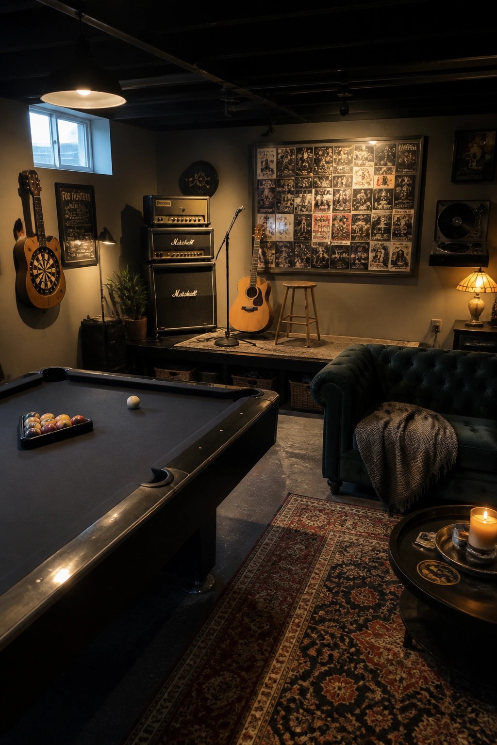 An indoor game room with a black pool table in the foreground, a dartboard on the left wall, a green tufted sofa on the right, and music equipment and posters along the back wall.