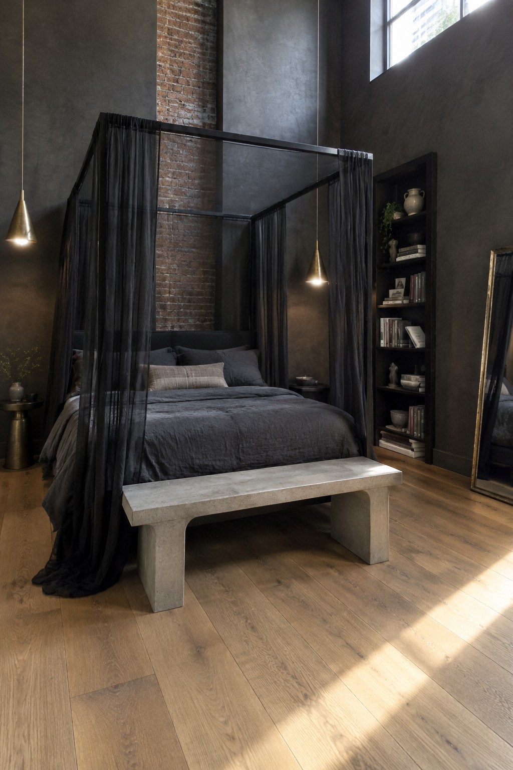 A black canopy bed with sheer dark curtains stands in a bedroom with charcoal walls, exposed brick, and wood flooring.
